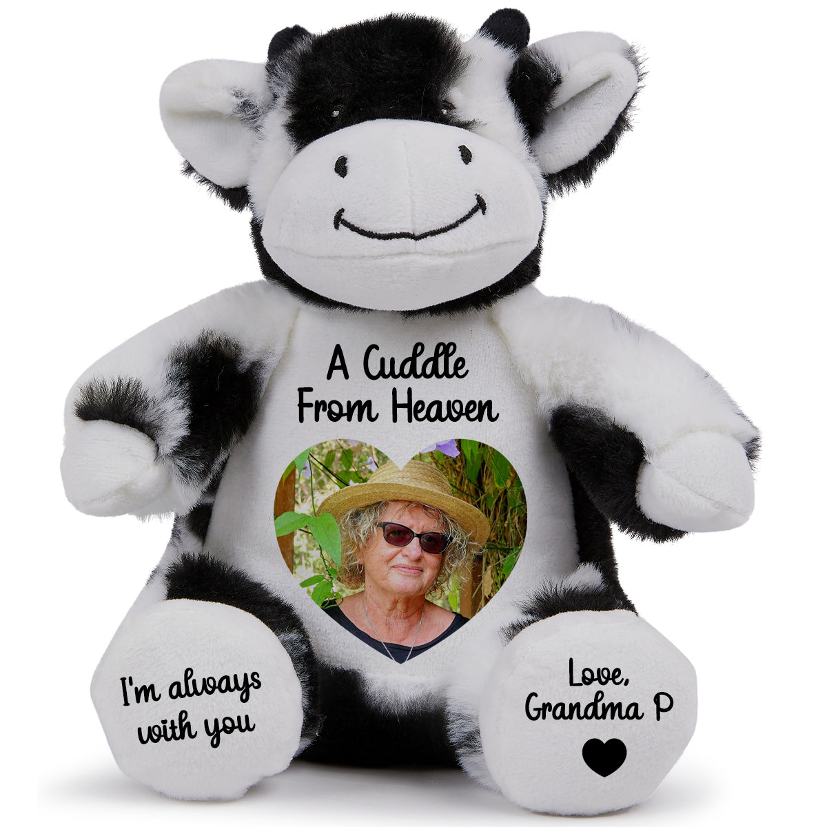 Plush cow teddy with a heart shaped photo and cuddle from heaven text on a white background