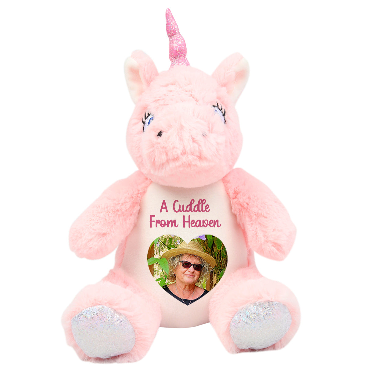 Pink unicorn plush toy with a heart-shaped photo and cuddle from heaven text on a white background