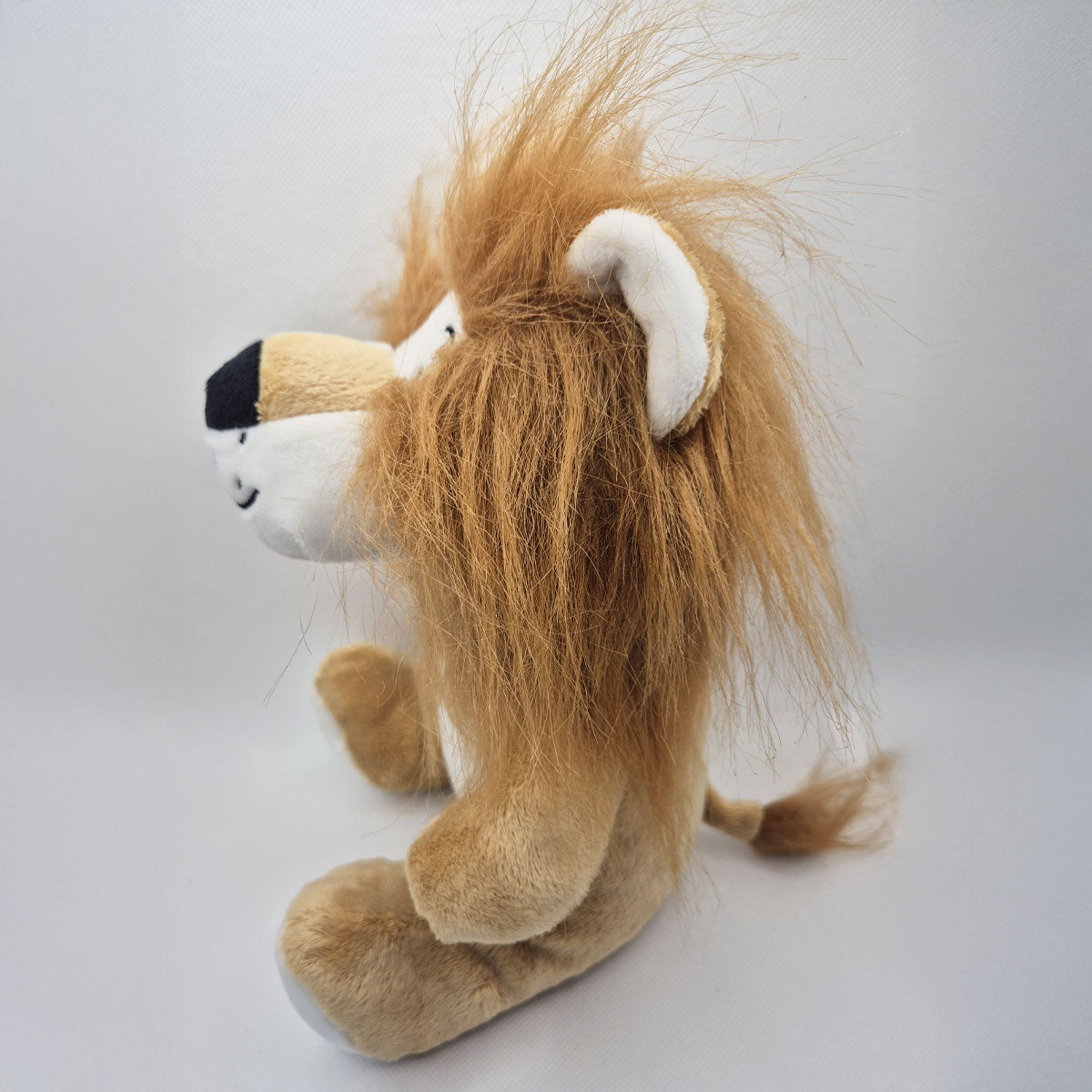 Plush lion toy with a white background