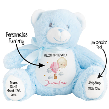Blue teddy bear with a personalized baby announcement card on a white background STOCK-BLUE