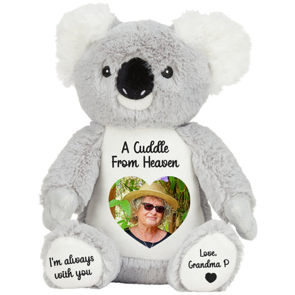 Plush koala teddy bear with a heart photo and cuddle from heaven text on a white background