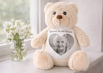 Teddy bear with a photo of an elderly woman on a white background