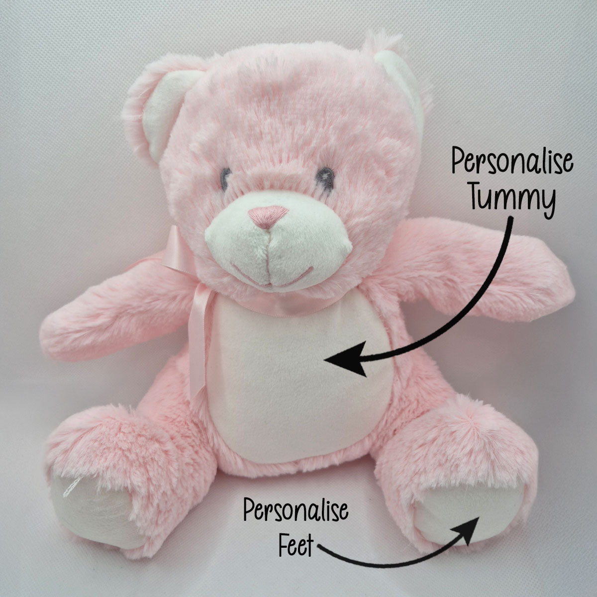 Pink teddy bear with text indicating areas to personalise on a light gray background
