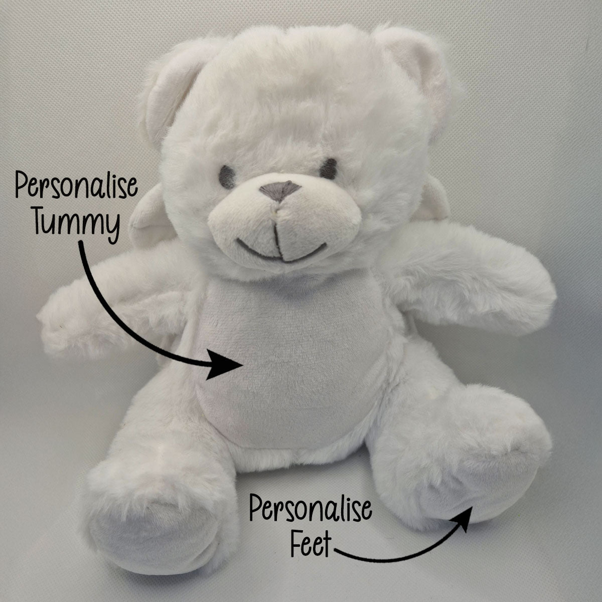 White angel teddy bear with text indicating areas to personalise on a white background
