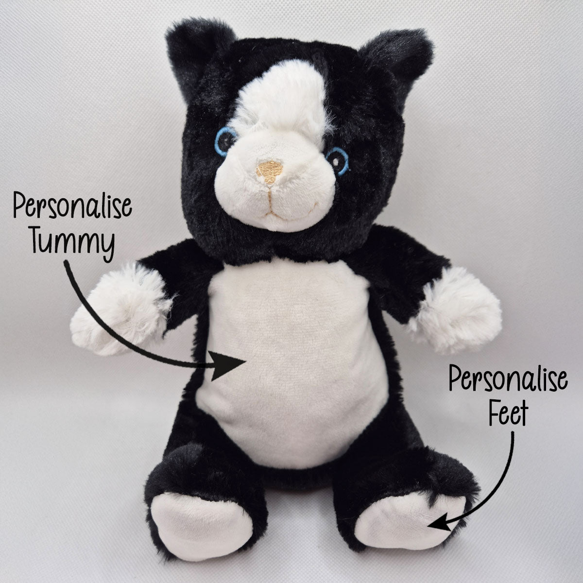 Black and white cat teddy with text indicating areas to personalise on a light grey background