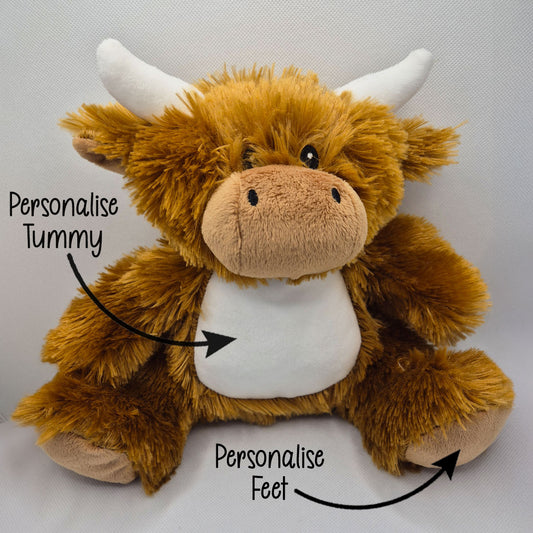 Plush toy cow with text indicating areas to personalize on a gray background
