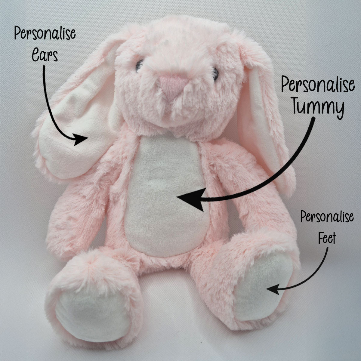 Pink plush bunny with text indicating areas to personalise on a white background
