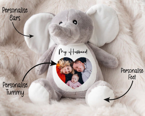 Plush elephant toy with customizable features on a soft surface