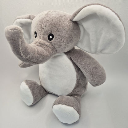 Side view of an elephant teddy toy on a light grey background